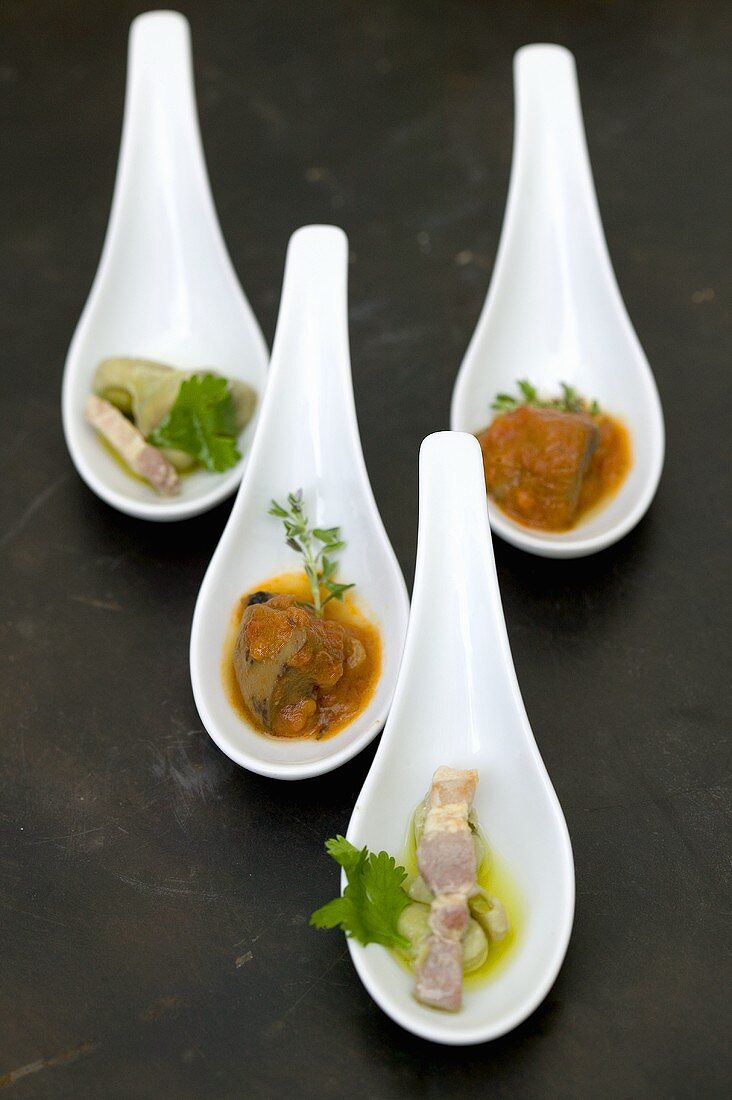 A selection of savoury appetisers served on china spoons
