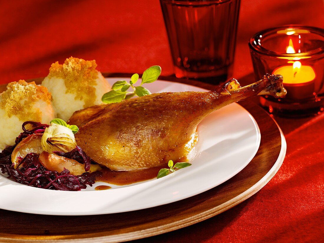 Leg of goose with apple red cabbage and potato dumplings