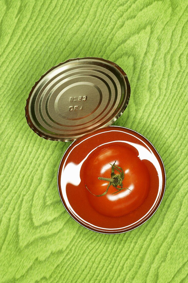 Fresh tomato in an opened tin