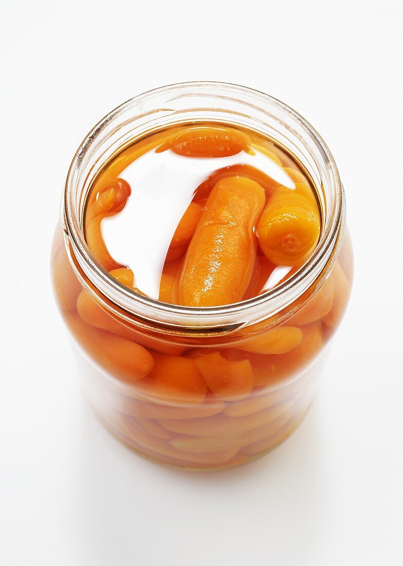 Carrots in a jar on a light background