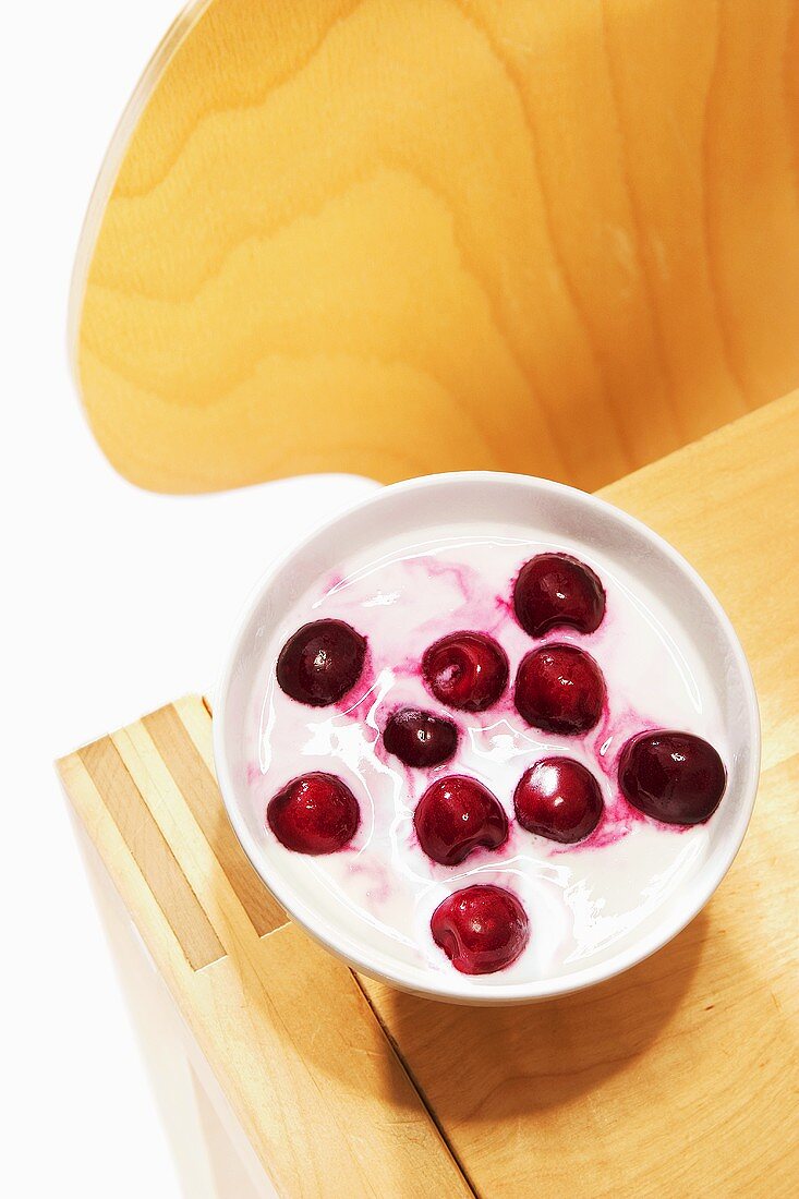 Bowl of yoghurt and cherries