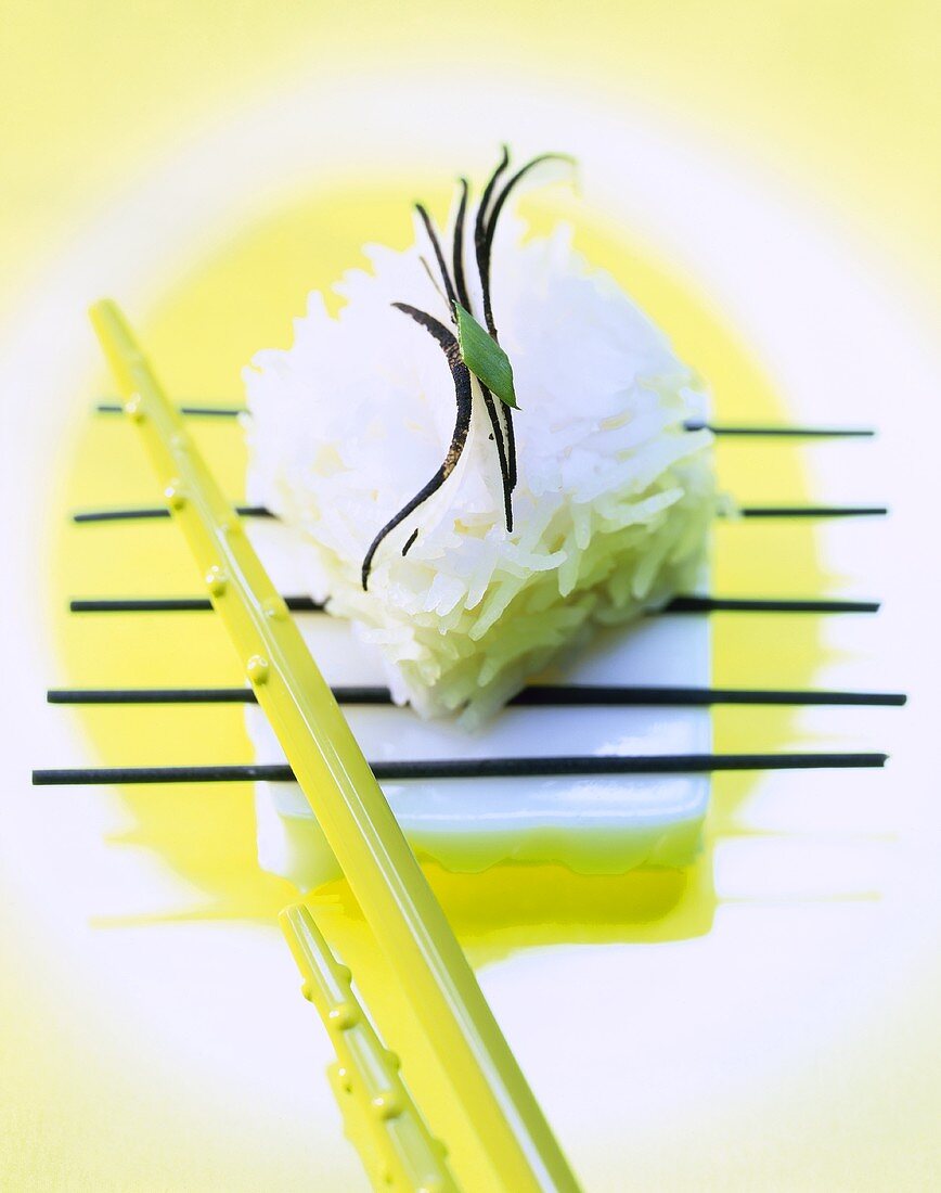 Cube of rice with chopsticks