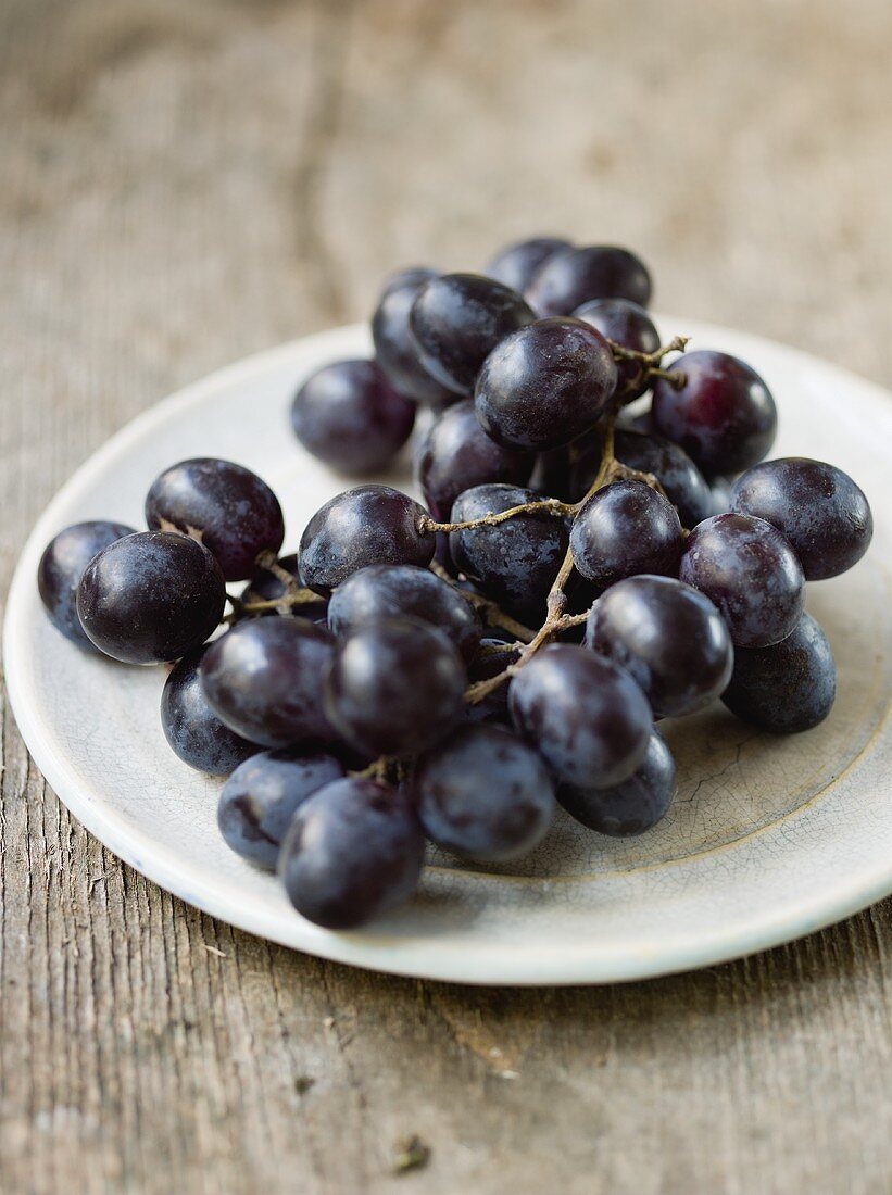 Black grapes on a plate