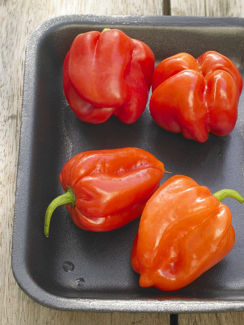 Four small red peppers