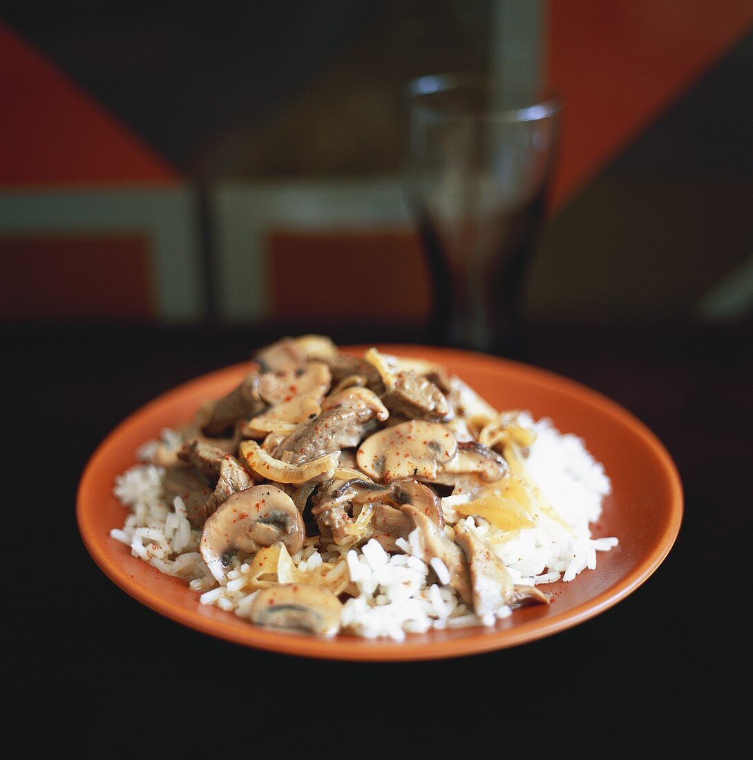Strips of meat with mushrooms on rice