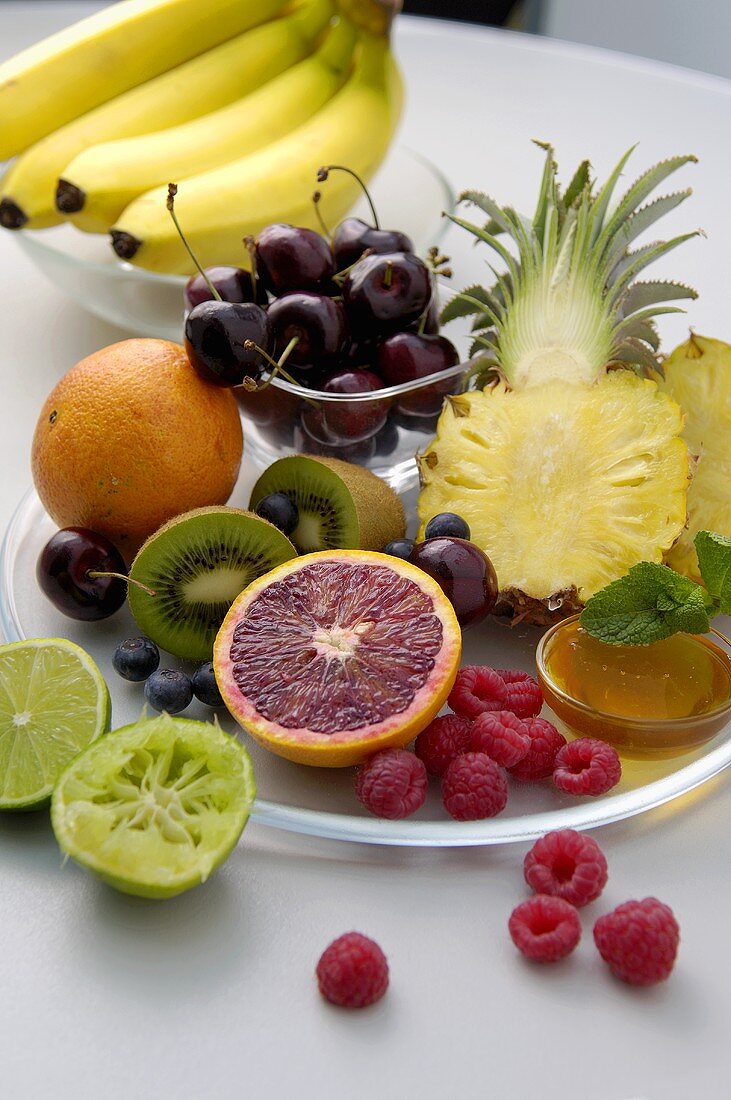 Ingredients for fruit salad: assorted fruit and honey