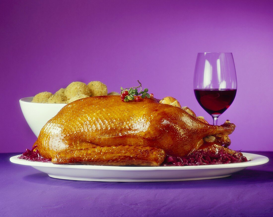 Roast goose with red cabbage, potato dumplings & red wine