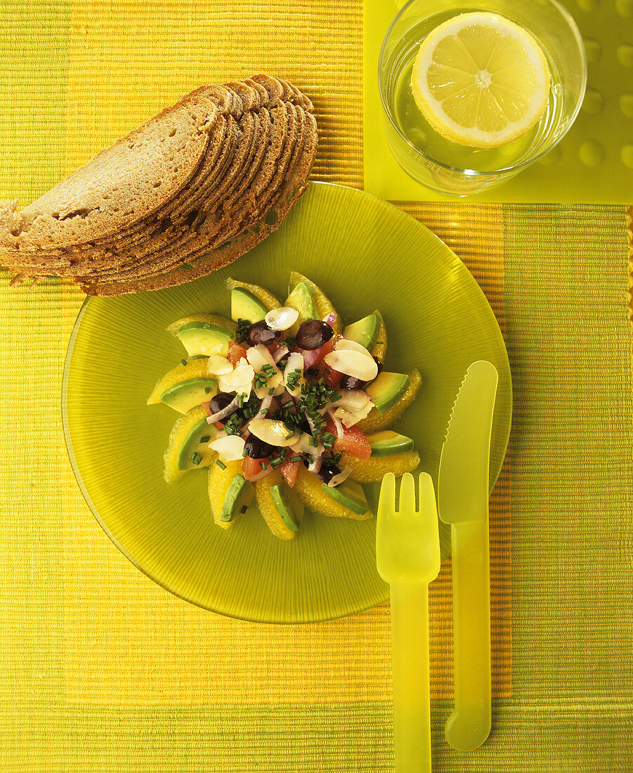 Salad of orange segments, avocado, olives and tomatoes