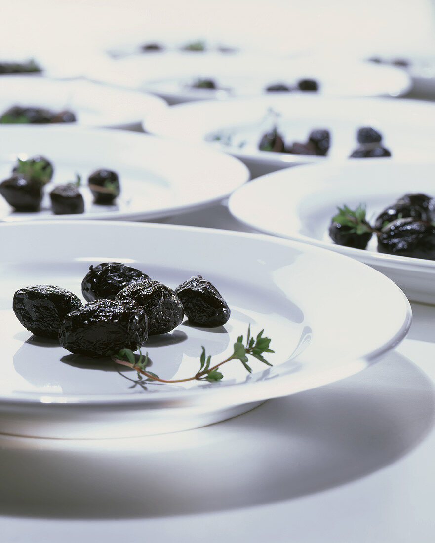 Black olives on white plates