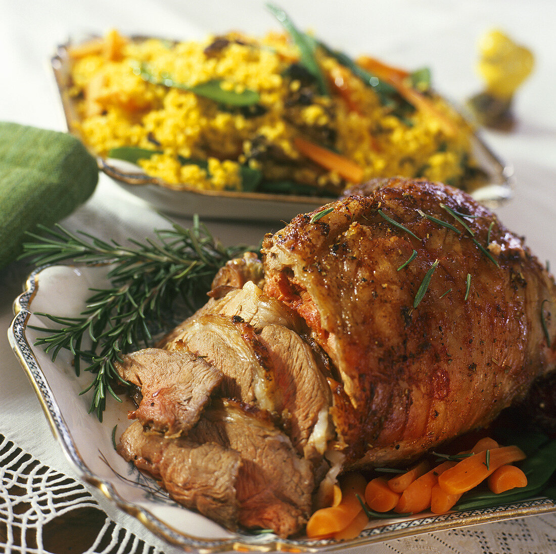 Roast lamb with a side dish of bulgur and vegetables
