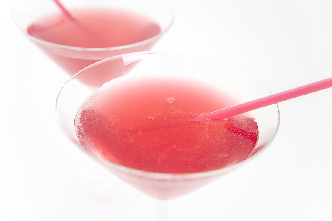 Two Cosmopolitan cocktails with straws