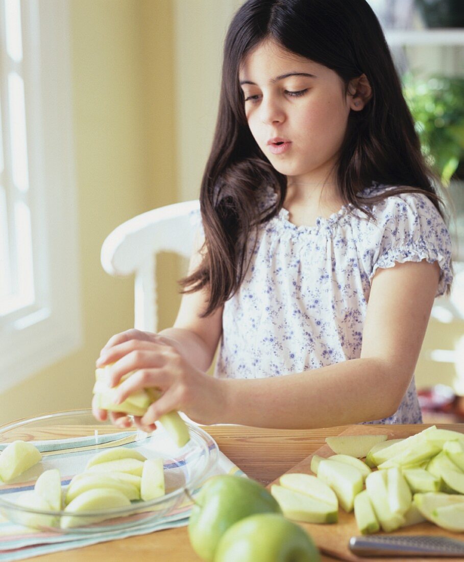 Girl with green apple slices (for apple cake)