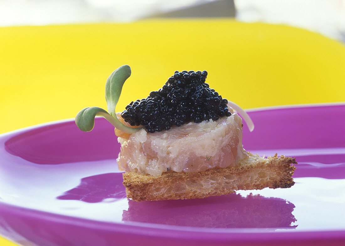 Toast triangle topped with salmon tartare and caviar