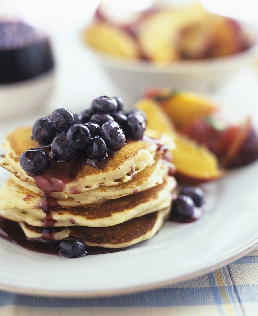 Pancakes with blueberries and fruit salad