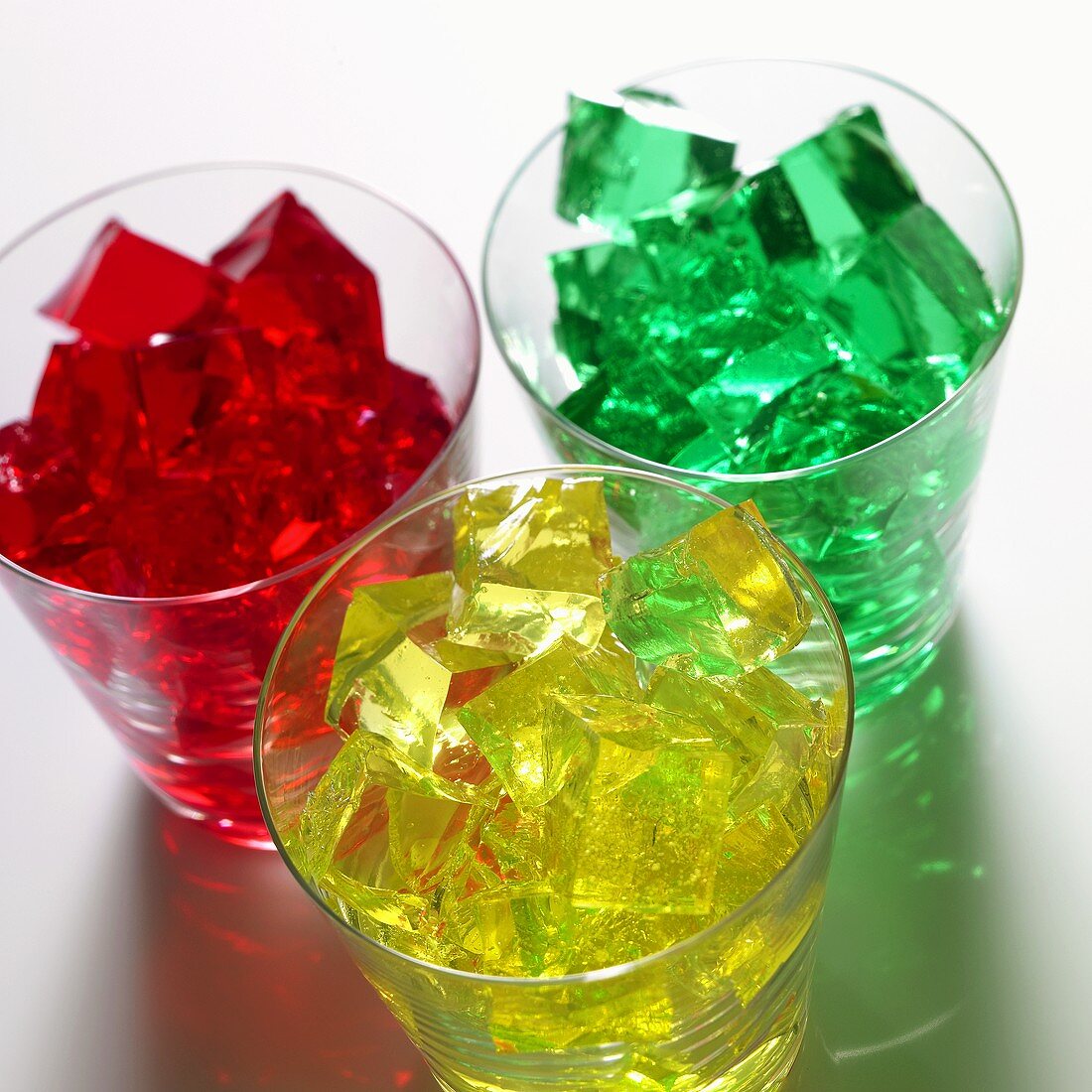 Cubes of red, yellow and green jelly in glasses