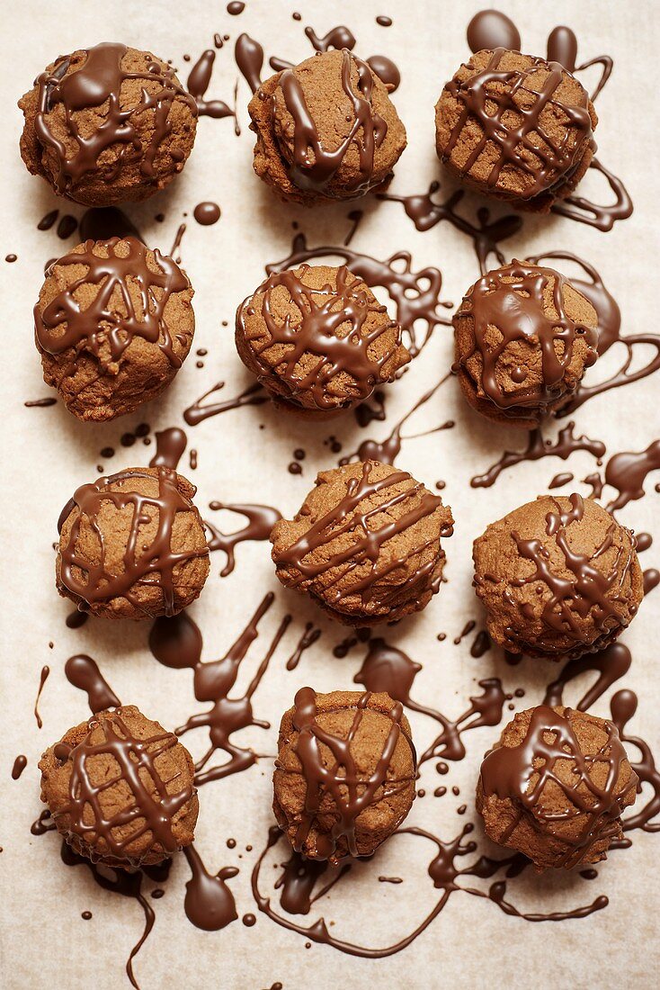 Filled chocolate cookies with chocolate piping