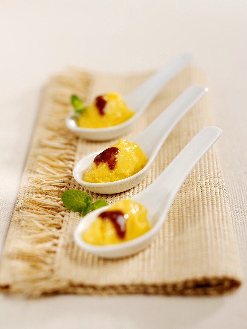 Mango and coconut mousse on three spoons
