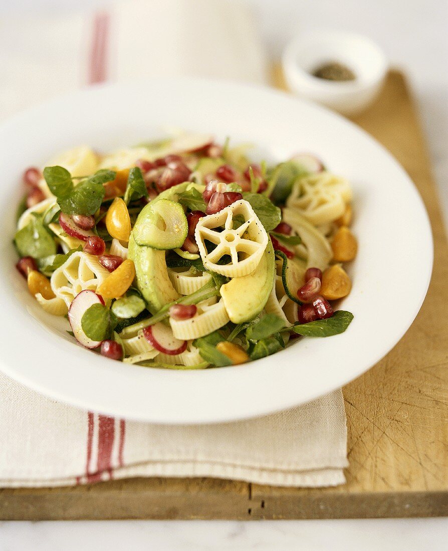 Pasta salad with vegetables and pomegranate seeds