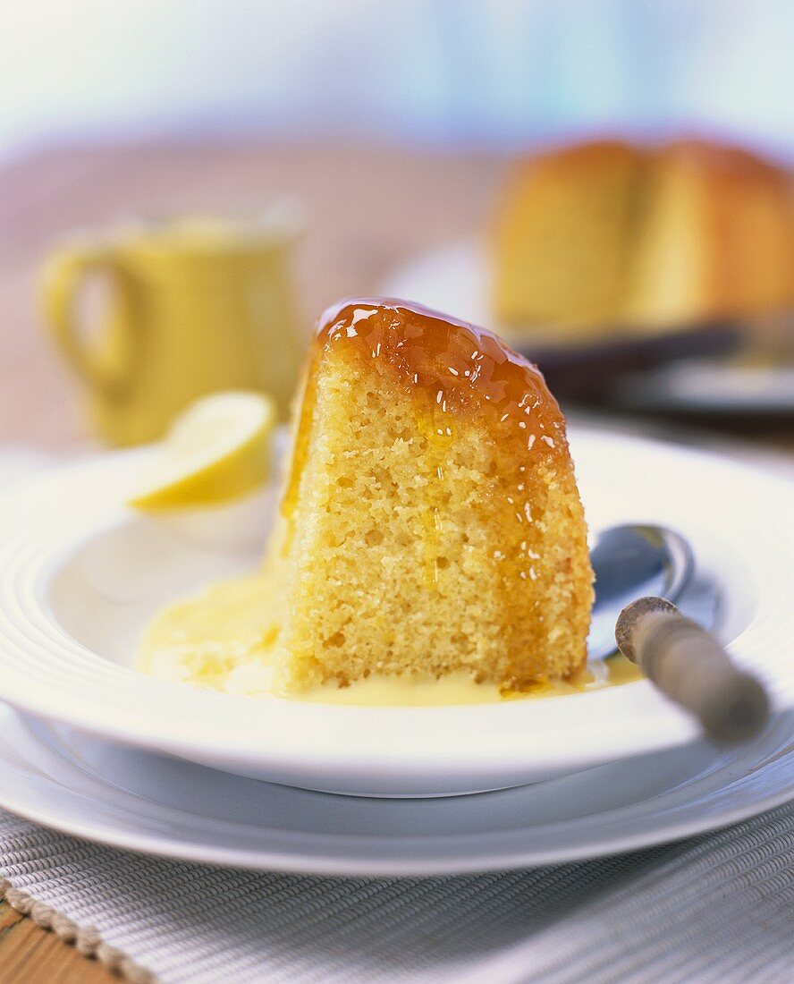 A piece of lemon cake with syrup in custard