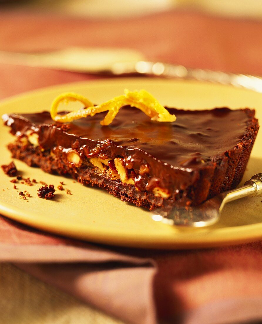A piece of chocolate tart with almonds