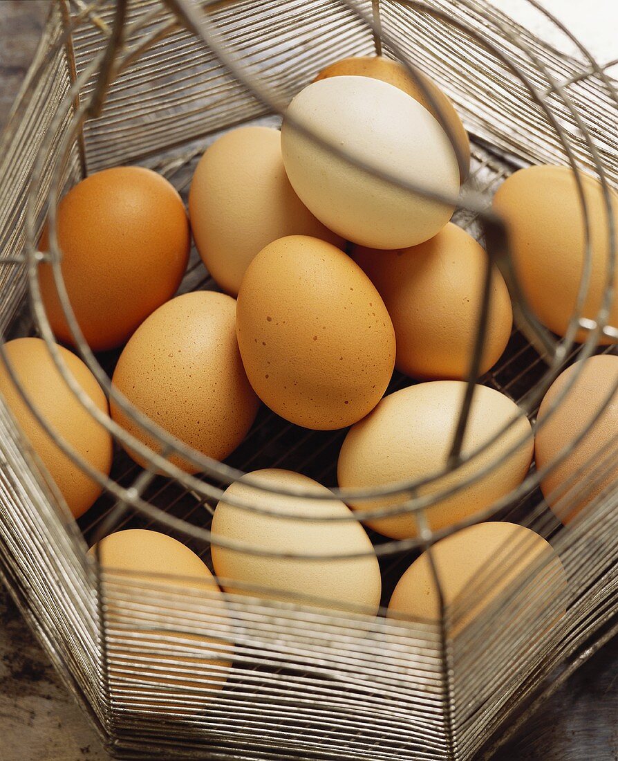 Several eggs in a wire basket