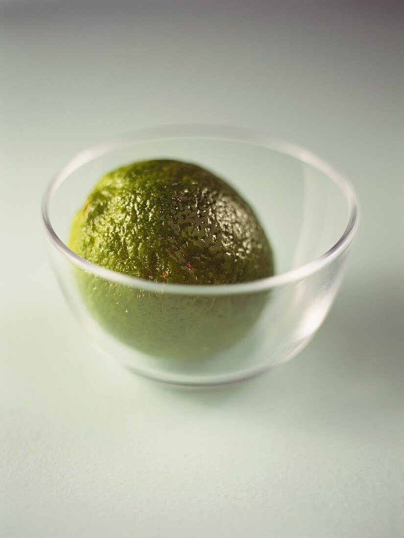 A lime in a small glass bowl