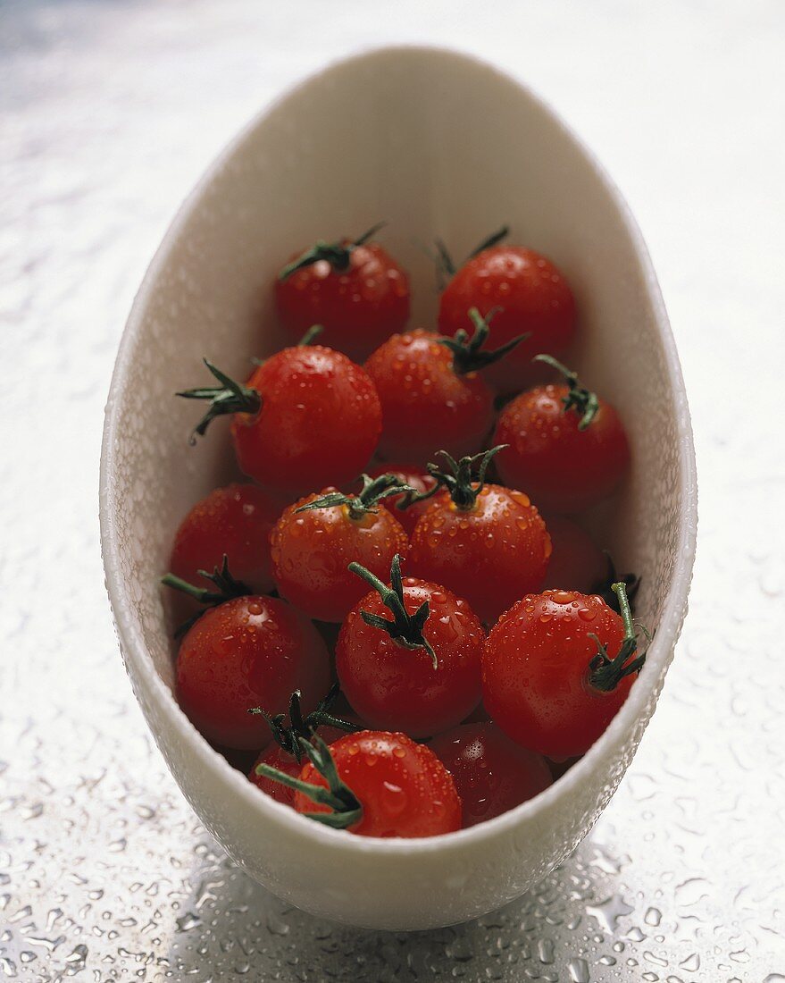 Several cherry tomatoes in a white dish