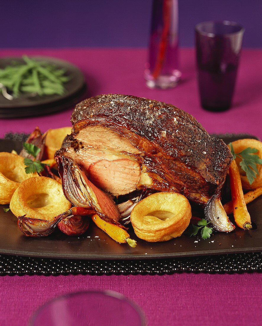 Roast beef with carrots, red onions and potatoes