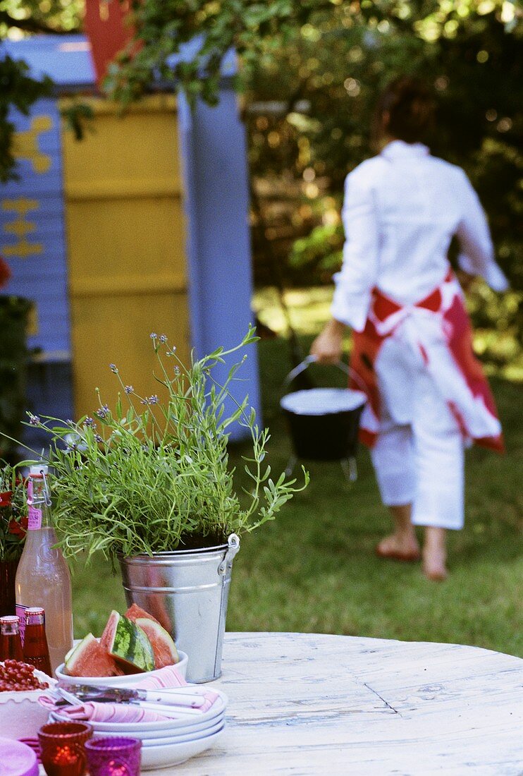 Woman carrying grill bucket