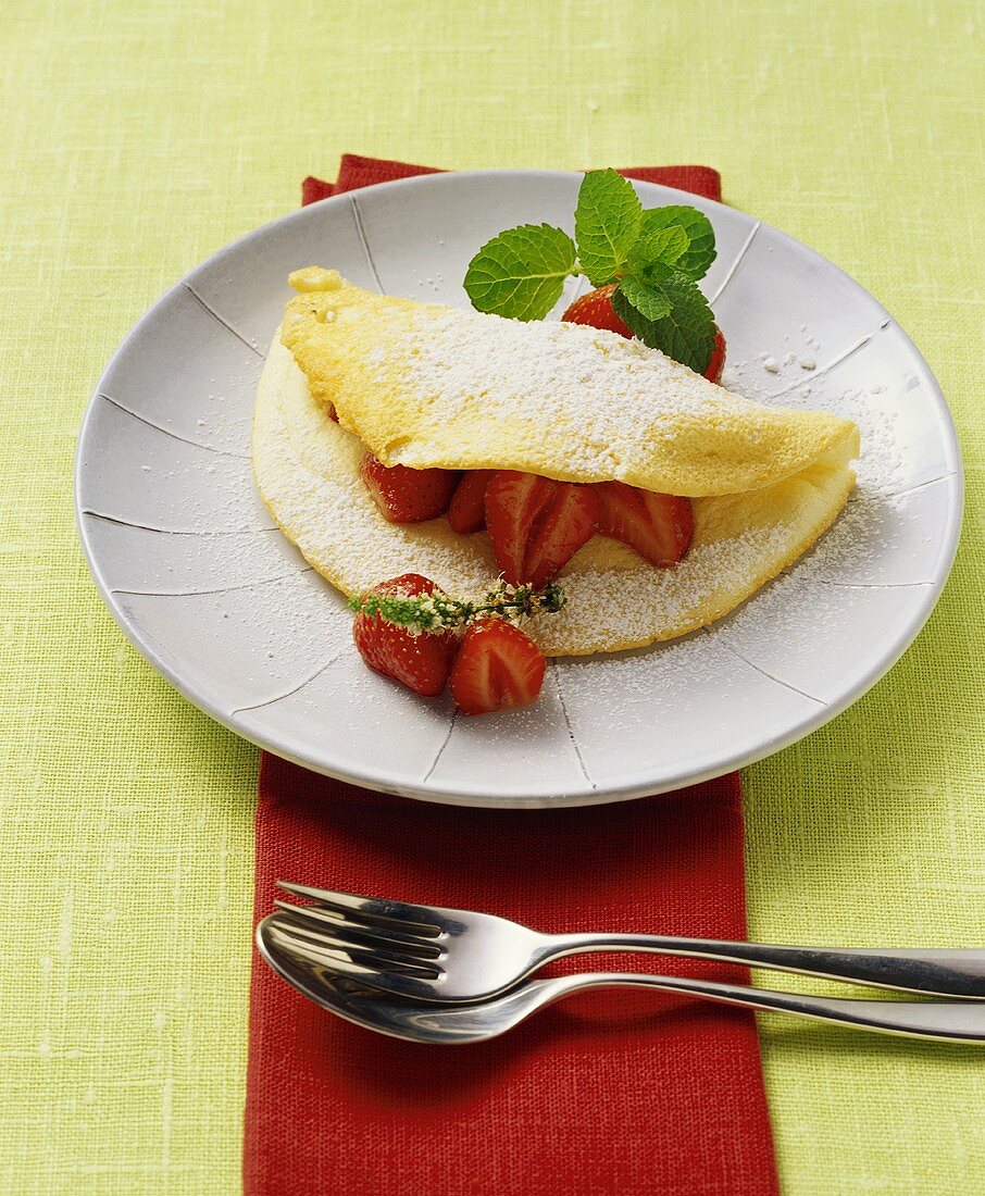 Soufflé omelette, folded over, with strawberries 