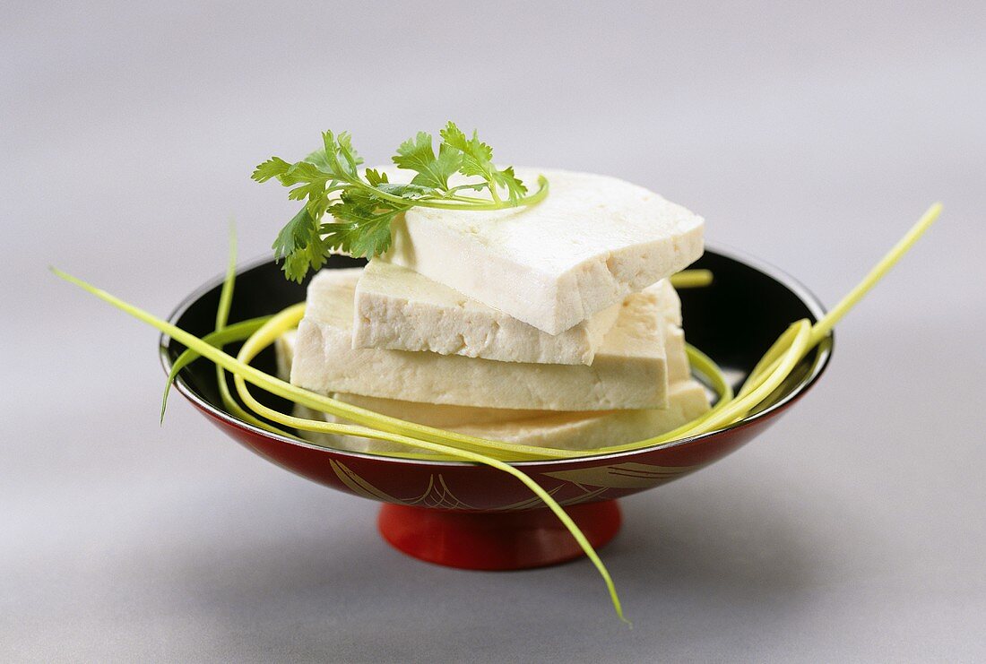 Several slices of tofu in a bowl