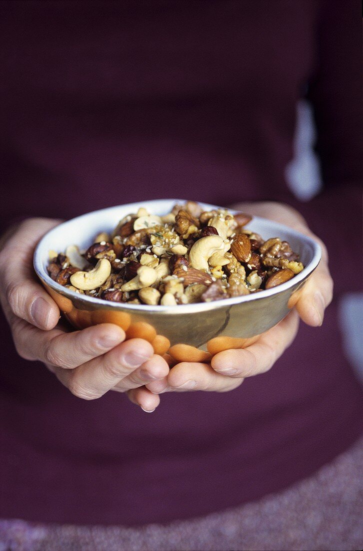 Woman holding a bowl of nuts