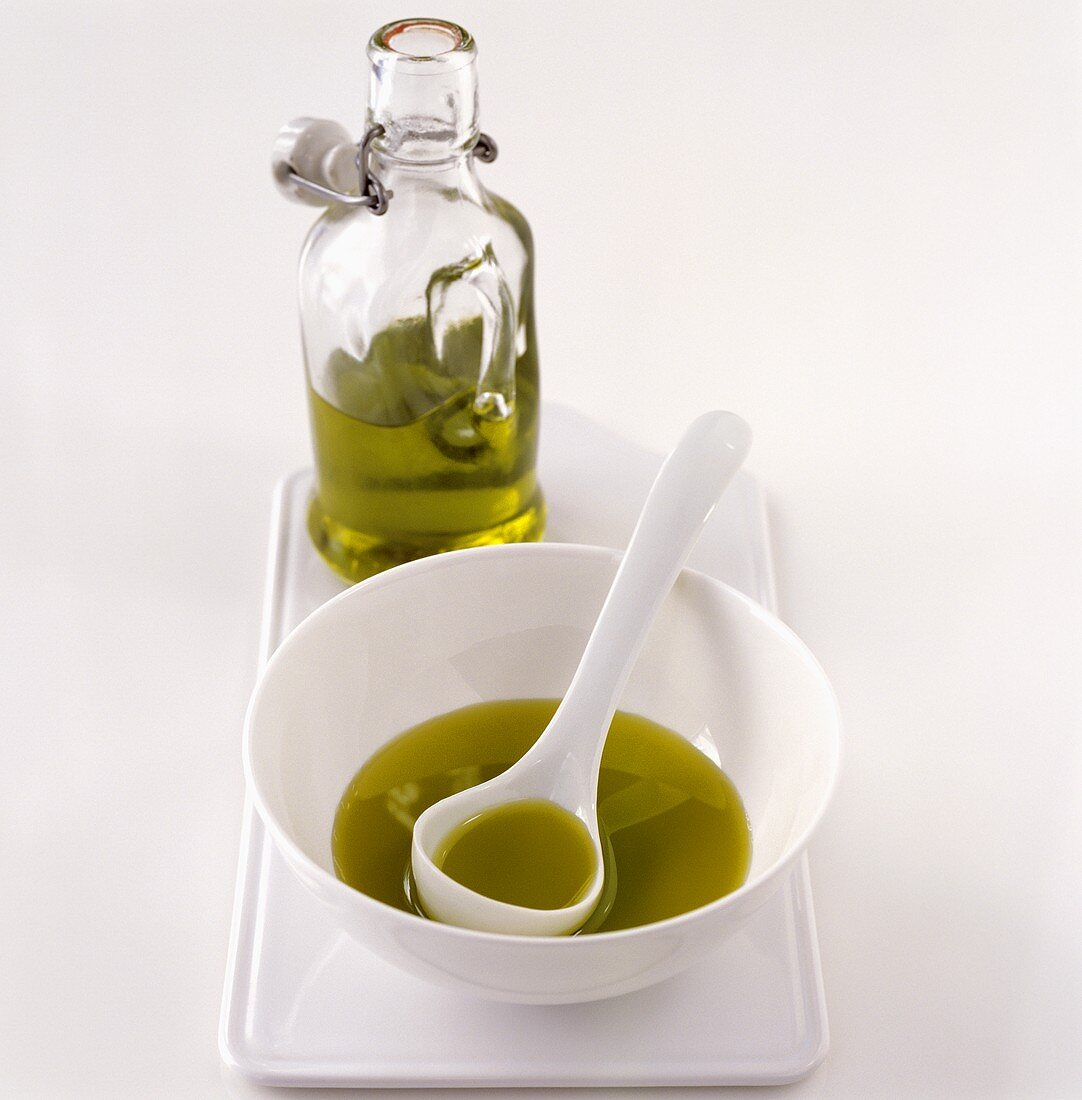 Olive oil in a bottle and a small bowl