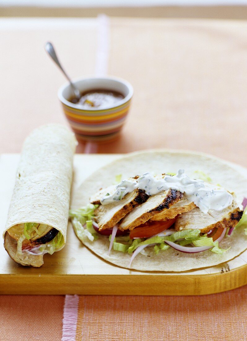 Wrap with spicy chicken, salad and minted yoghurt