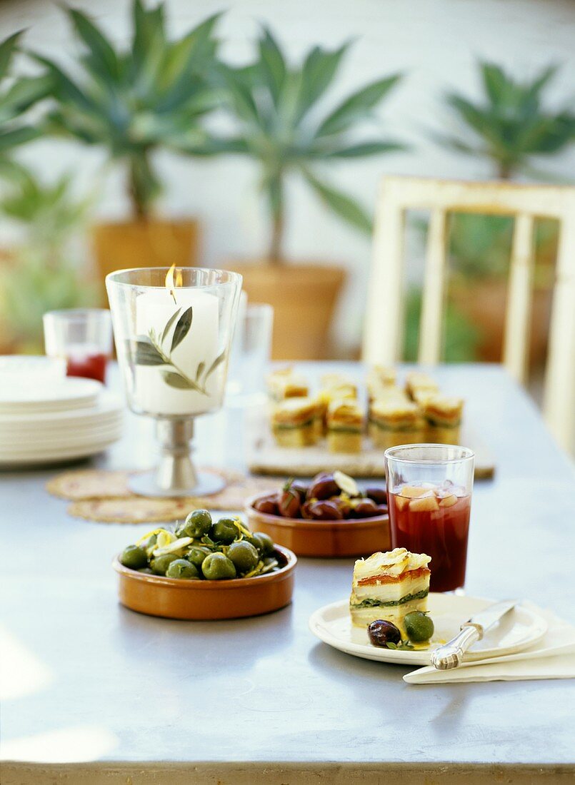 A table with olives and potato snacks