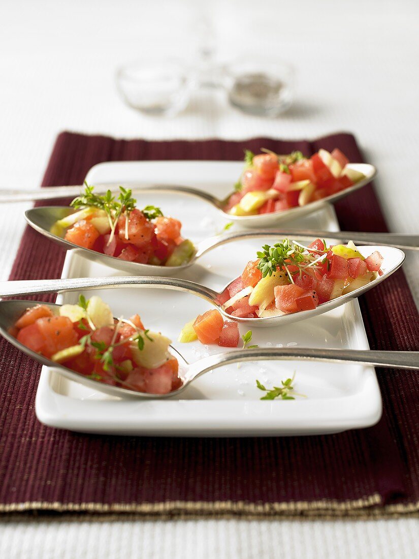 Diced salmon and vegetables in four spoons