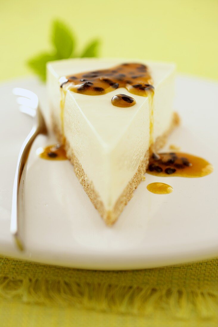 A piece of cheesecake with passion fruit sauce