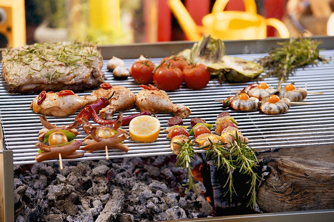 Assorted barbecued dishes on a grill rack