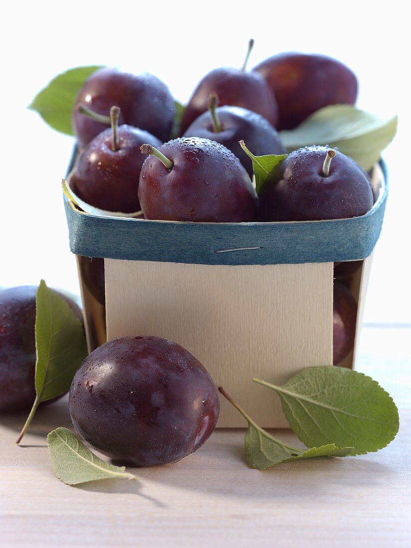 Plums in a wooden basket
