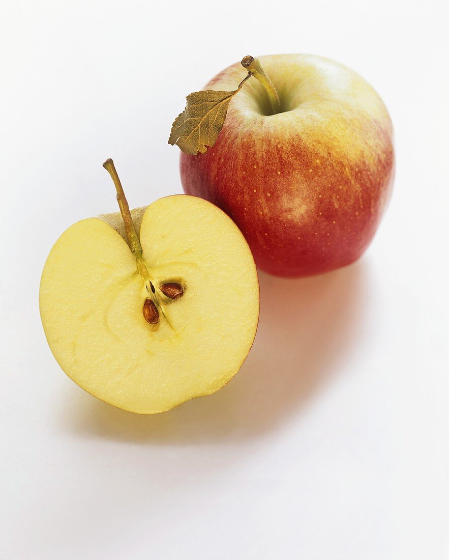 A Whole and Halved Braeburn Apple
