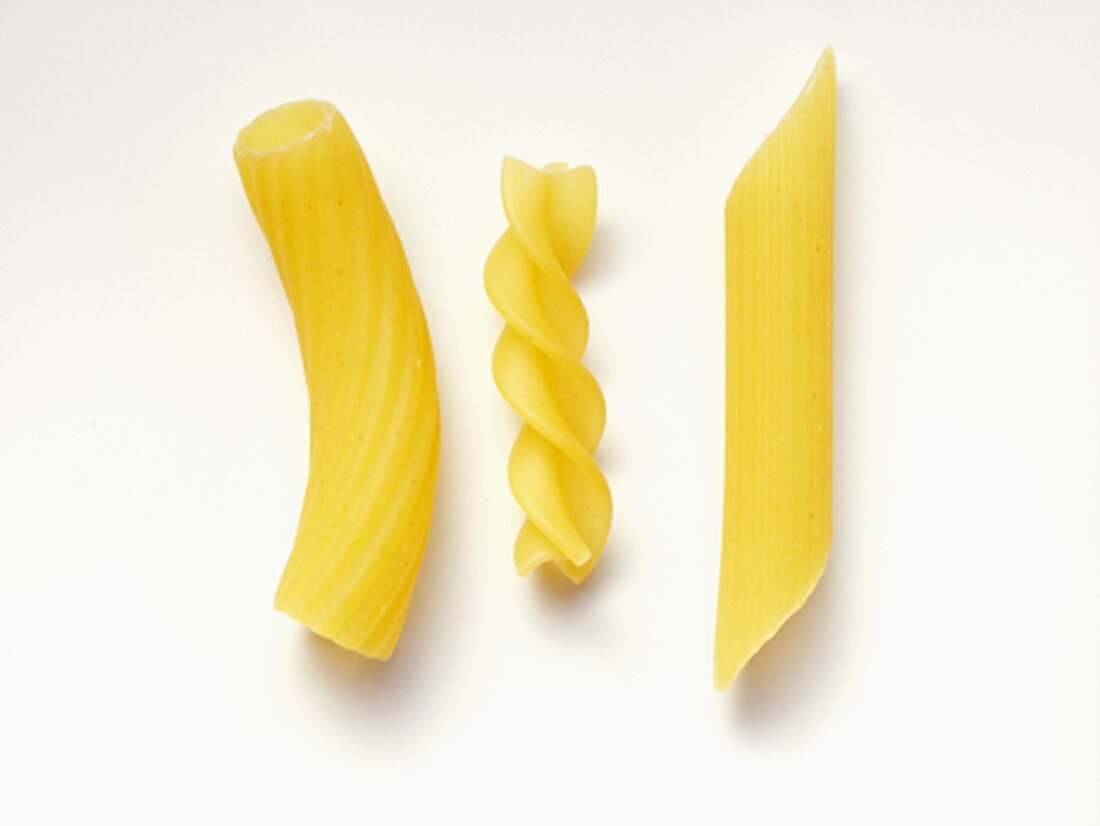 Three Types of Uncooked Pasta Macaroni, Fusilli and Penne