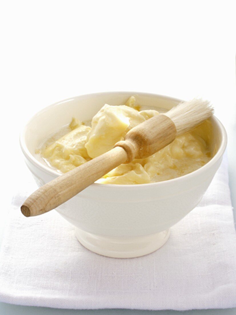 Partially Melted Butter in White Bowl with Pastry Brush