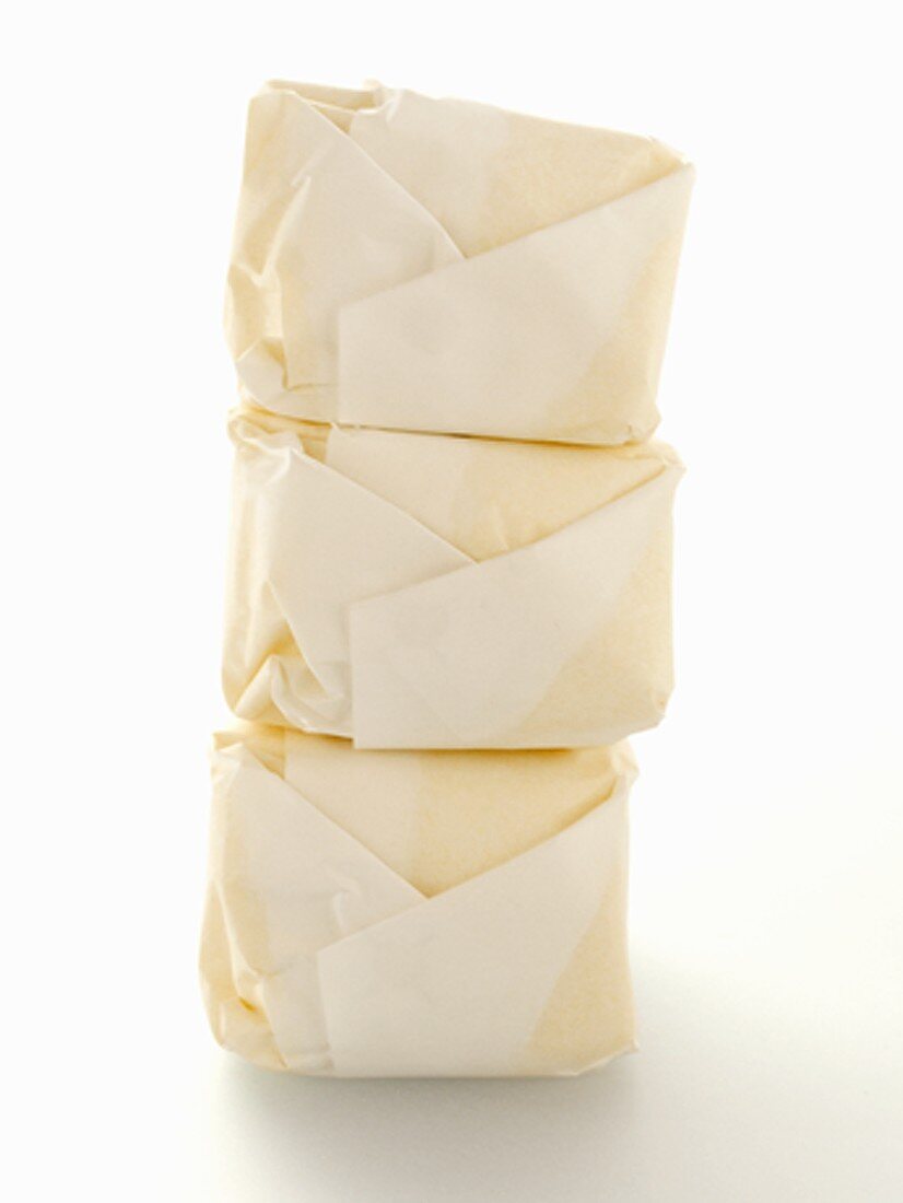 Three Cubes of Butter in Wrappers