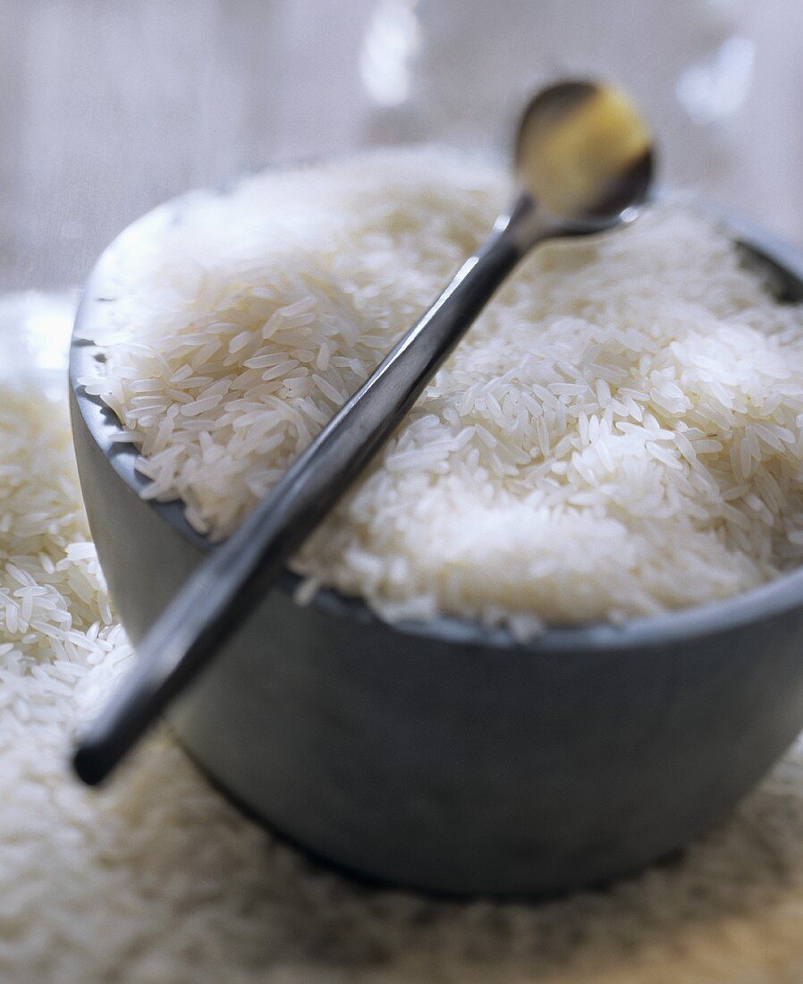 Uncooked Jasmine Rice in a Bowl with a Spoon