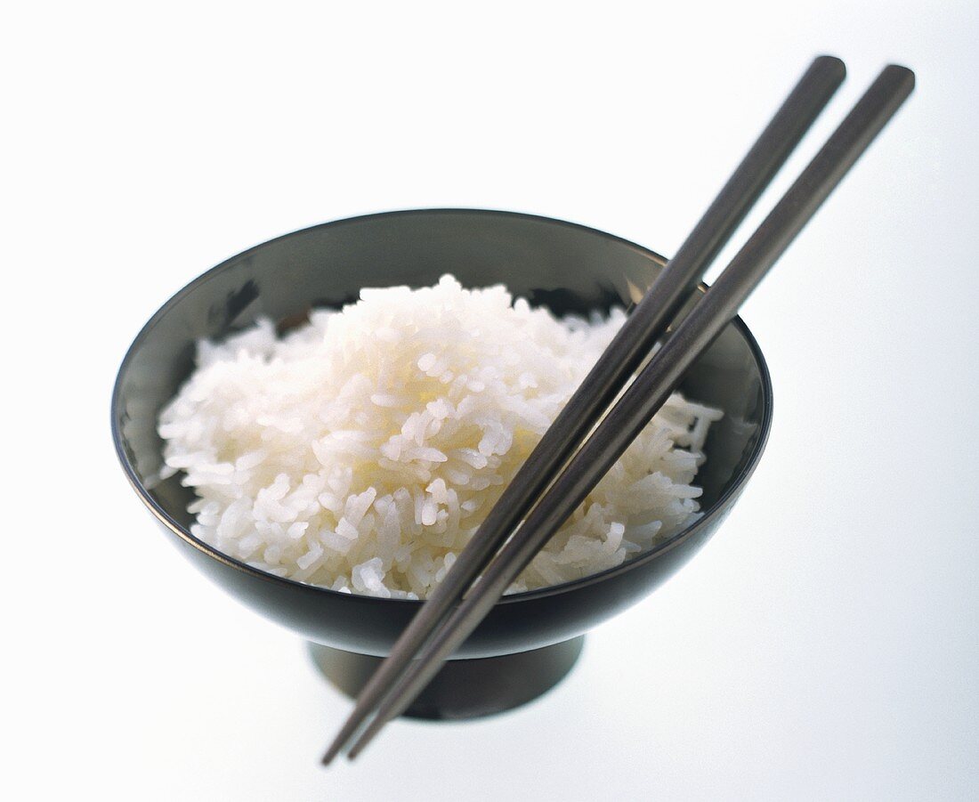 A Bowl of Cooked Jasmine Rice with Chopsticks
