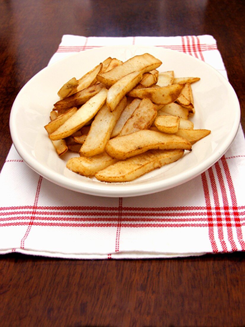 A Bowl of Steak Fries on a Napkin