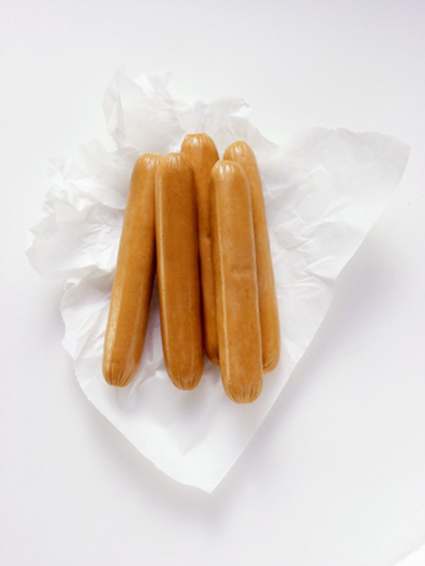 Uncooked Hot Dogs on Paper