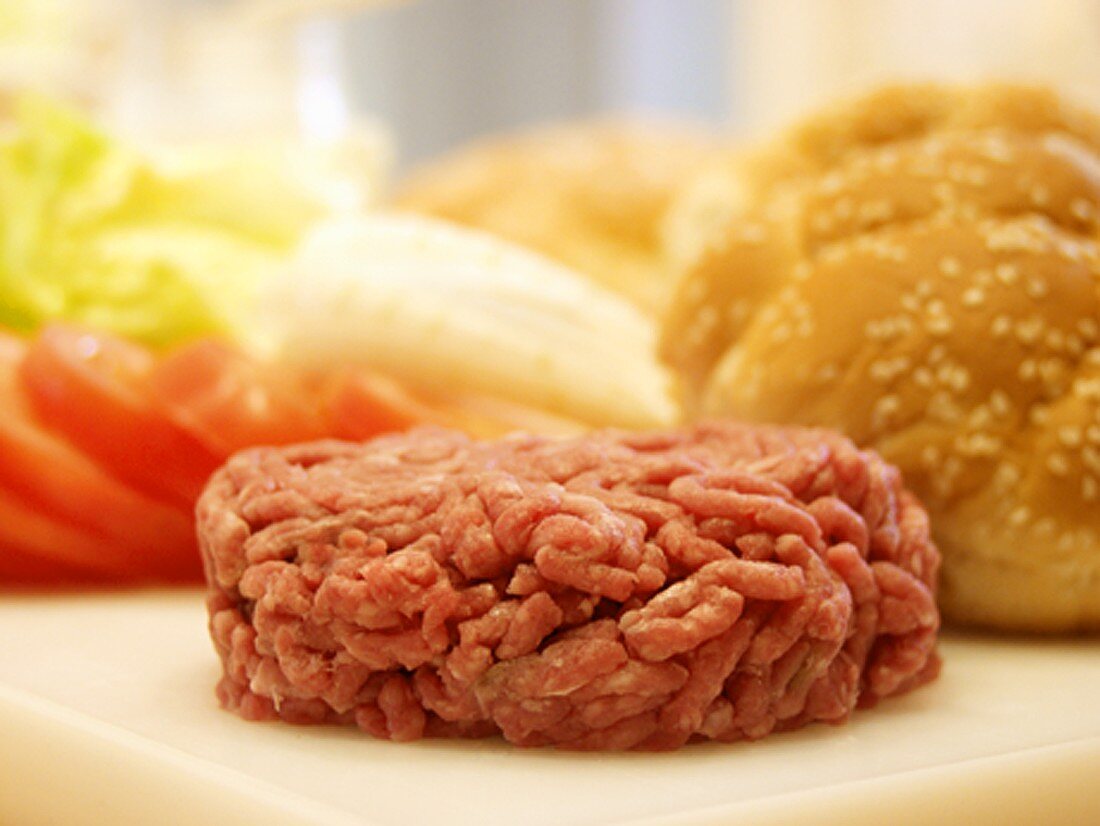 A Hamburger Patty with Bun and Vegetables