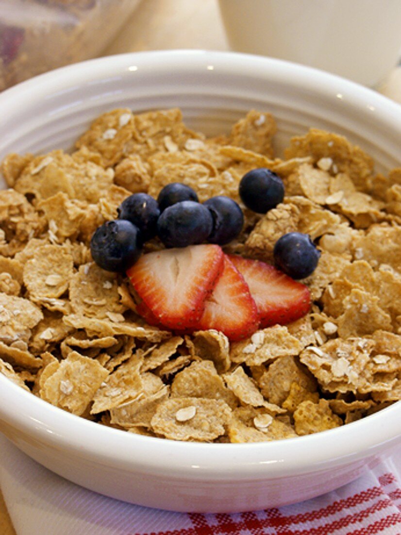 A Bowl of Cornflakes with Strawberries and Blueberries