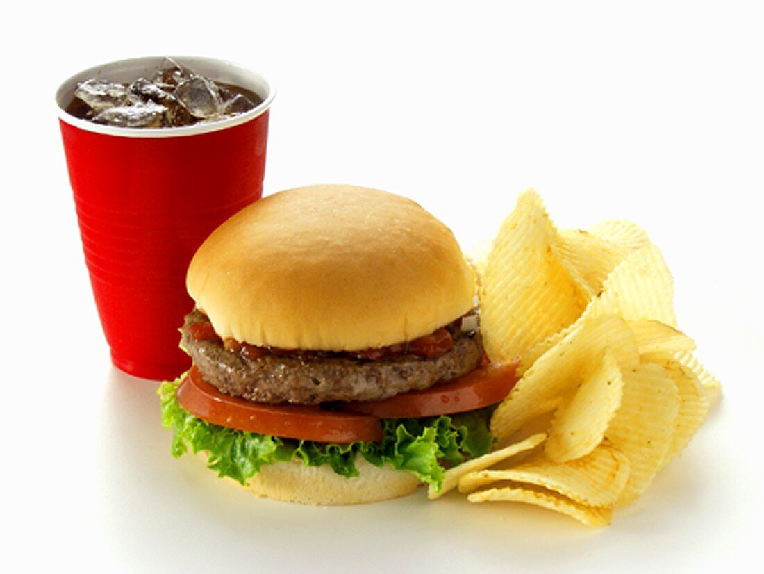 A Hamburger with Potato Chips and Soda